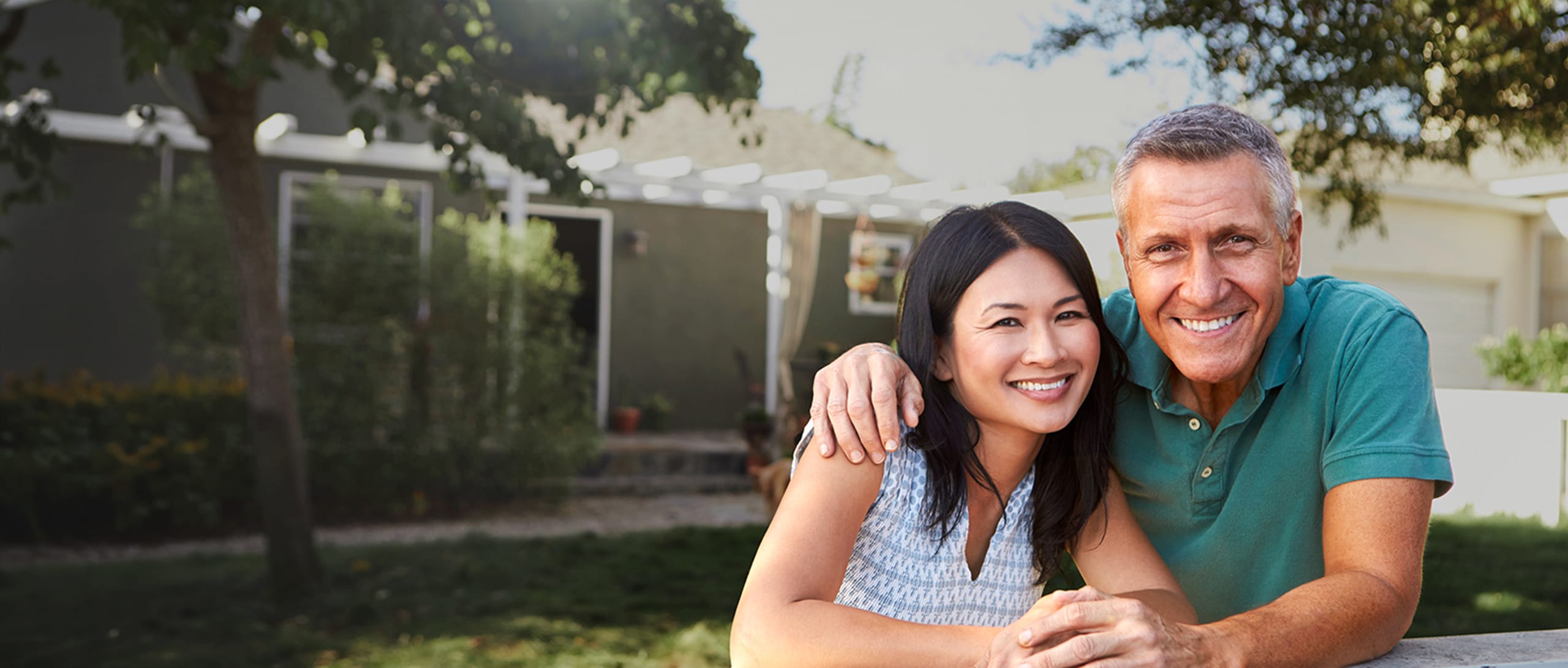 A woman and a man smiling happily.